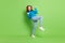 Full size photo of positive cheerful happy teenage girl winner celebrate smile isolated on green color background