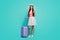 Full size photo positive girl tourist use cellphone book taxi service hold purple suitcase enjoy travel weekend wear