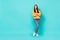 Full size photo of pretty nice lady with folded arms looking empty space isolated over cyan color background