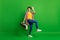 Full size photo of pretty positive lady dancing hold boombox wear jeans shirt sneakers  on green background
