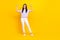 Full size photo of pretty stylish strong cheerful girl raise arm show biceps power stand empty space isolated on yellow