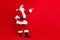 Full size photo of satisfied grandfather wear santa costume demonstrate offer empty space arm on waist isolated on red