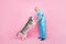 Full size photo of senior good mood professional doctor wear blue uniform hold paws husky checkup isolated on pink color
