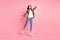 Full size photo of sweet short hairdo lady jump wear khaki shirt jeans sneakers isolated on pink color background