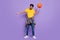 Full size photo of unhappy afro american young clueless man hold ball spin isolated on violet color background