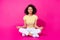 Full size photo of young attractive woman sitting relax meditation concetrated dreamy isolated on pink color background