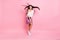 Full size photo of young beautiful positive flirty coquettish girl with flying hair dancing  on pink color