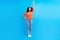 Full size photo of young cheerful african woman happy positive smile power superhero isolated over blue color background