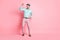 Full size photo of young crazy smiling cheerful man dancing listen music in headphones isolated on pink color background