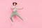 Full size photo of young girl happy positive smile sport karate jump up isolated over pink color background