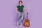 Full size photo of young handsome guy happy positive smile music lover guitar  over violet color background