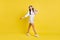 Full size photo of young happy cheerful smiling positive girl dancing listen music isolated on yellow color background