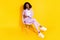 Full size photo of young happy cheerful smiling representative afro woman sit chair  on yellow color background
