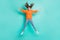 Full size photo of young happy excited smiling funny careless girl jumping in star pose isolated on turquoise color