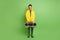 Full size photo of young happy positive handsome funky man wear coat hold boombox isolated on green color background