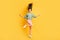 Full size photo of young lovely good looking smiling cheerful positive girl with flying hair isolated on yellow color