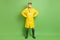 Full size photo of young man in raincoat and goggles wear face mask protection from coronavirus isolated on green color