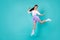 Full size portrait of active cute indonesian lady have fun jumping freedom isolated on aquamarine color background