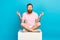 Full size portrait of calm peaceful guy sit podium crossed legs meditate retreat  on blue color background