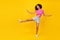 Full size portrait of carefree crazy person raise one leg enjoy free time dance isolated on yellow color background