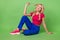 Full size portrait of gorgeous cheerful minded girl sit floor play curls look empty space  on green color