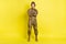 Full size portrait of military girl standing crossed arms look camera isolated on vivid yellow color background