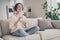 Full size portrait of pretty positive young girl hands hold popcorn plate look curious beaming smile indoors