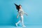 Full size profile photo of adorable walking person hair flying wear white green isolated on blue color background