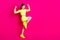 Full size profile photo of astonished young lady stand fists up yell look empty space dress sport suit isolated on pink