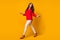 Full size profile photo of attractive business lady walk street work look back empty space meet colleague wear red