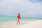 Full size profile photo of beautiful lady long blonde hair walk blue water skinny figure exotic resort empty desert