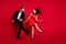 Full size profile photo of funky couple dance wear vivid dress black suit isolated on red color background