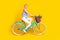 Full size profile photo of optimistic blond hair lady ride bicycle wear top pants isolated on yellow background