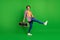Full size profile photo of pretty funky lady dancing hold boombox wear jeans shirt sneakers  on green background