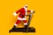 Full size profile portrait of elderly fat santa walk treadmill prepare christmas time empty space isolated on yellow