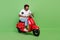 Full size profile side photo of young excited african man speed fast rider isolated over green color background