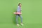 Full size profile side photo of young girl happy positive smile sport hold longboard skater isolated over green color