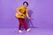 Full size profile side photo of young guy happy positive smile play guitar artist isolated over purple color background