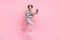 Full size profile side photo of young woman happy positive smile go walk jump online laptop isolated over pink color