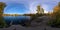 Full spherical 360 by 180 degrees panorama of evening autumnal lake with birch forest on its shores