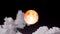 Full strawberry blood moon rise on night sky and gray cloud moving pass