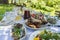 Full table of ukrainian meals on the table for eat. Table with many ready meals and food in the summer garden, outdoors, closeup
