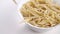 Full white bowl of traditional Italian trofie pasta close up. Rotation