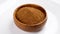 Full wooden bowl of brown coconut sugar on white. Coco nut natural sweetener.