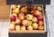 Full wooden box shelf with healthy red apples