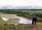 Full Yakut Asian girl posing for a photo stands on the edge of a cliff on the background of taiga forest