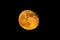 Full yellow moon. Light star. lunar craters.