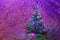 Fully decorated illuminated Christmas tree with ornaments on snowy spruce branches