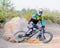 Fully Equipped Professional Downhill Cyclist Riding the Bike on the Dusty Trail. Extreme Sports