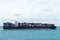 Fully loaded, cargo container ship departing from port of Singapore.